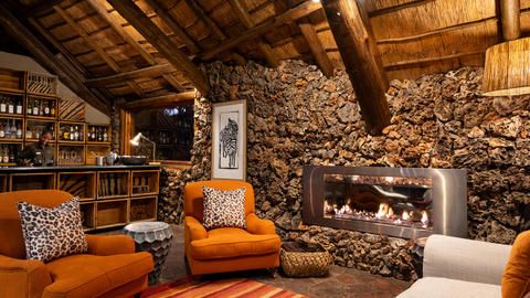 Ongava Lodge - Communal lounge fireplace