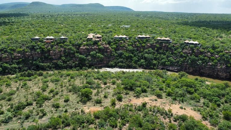 Noka Camp Aerial View - Sitting on top of a spectacular 100 ft rock face with the swirling Palala River below, Noka Camp encourages complete tranquility with uncompromised luxury.