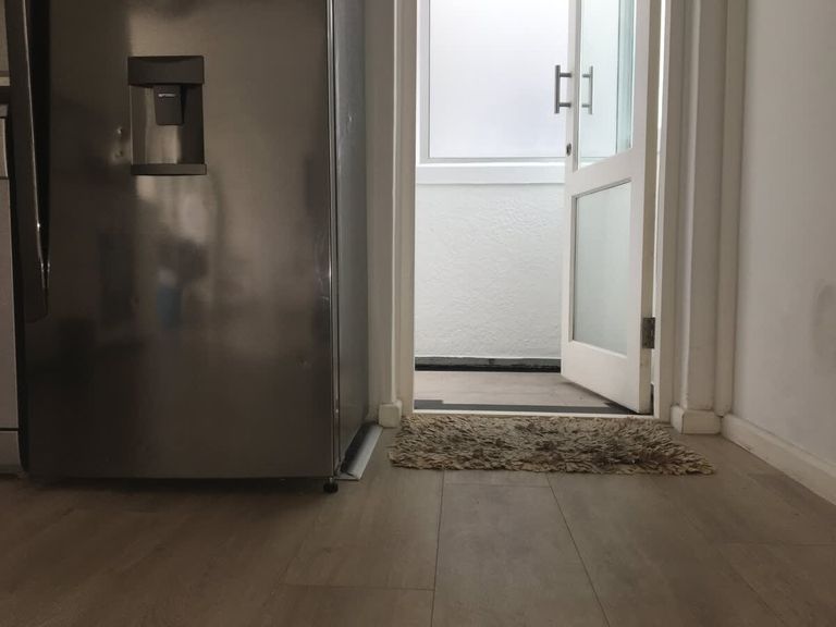 Front door leading to a single level apartment