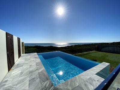 Leisure beach front home with a fully tiled pool.