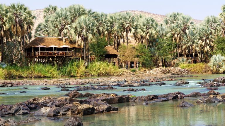 Epupa Falls Lodge - View of Epupa Falls Lodge from across the river