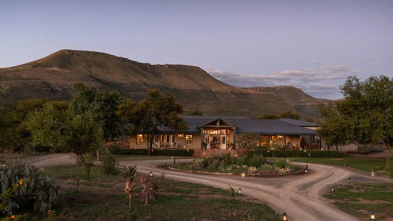Karoo Lodge entrance - The reception exterior showcases an inviting entrance with clear signage and well-maintained landscaping. It provides easy access for guests and sets a welcoming tone before they step inside.