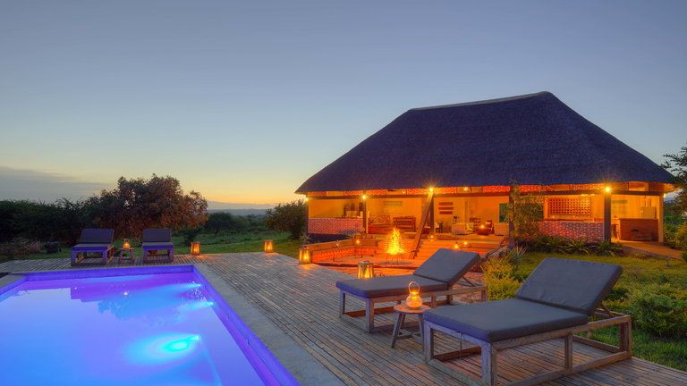 Bar and lounge area - The glow of the pool and bar area at night