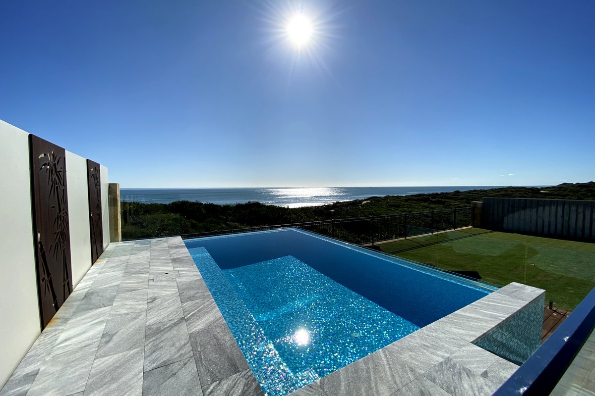 Leisure beach front home with a fully tiled pool.